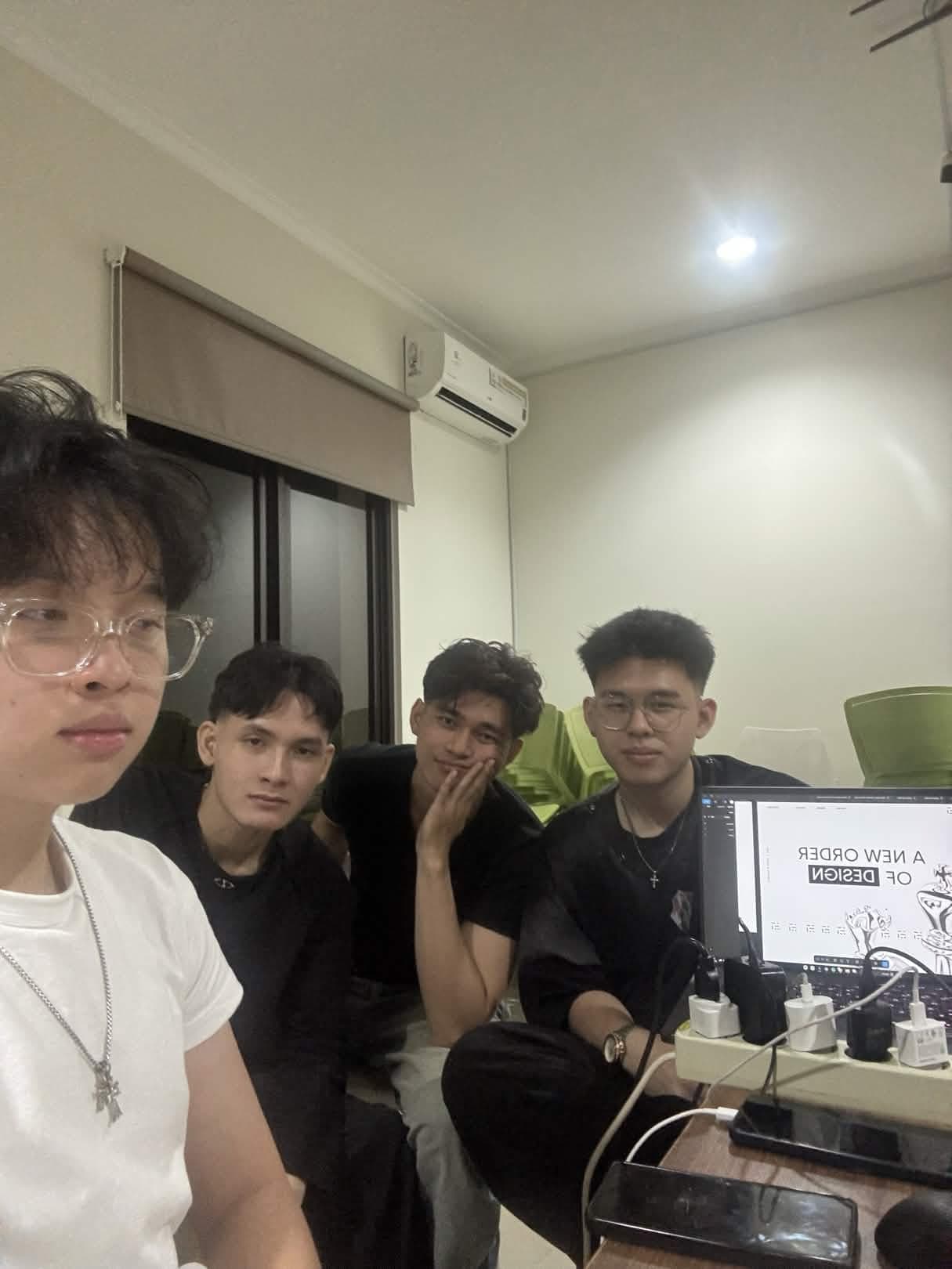 Group of four friends in a casual room setting